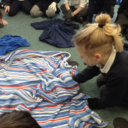 We investigated our sense of touch. Things were hidden under a blanket and we had to use our sense of touch to find out what the item was. It was even harder with gloves on!